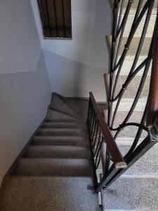 a stairway with a metal railing and a stair case at Ca' Dell' Arte Luxury in Venice