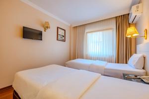 A bed or beds in a room at Peak Star Hotel