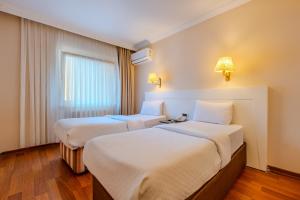 A bed or beds in a room at Peak Star Hotel