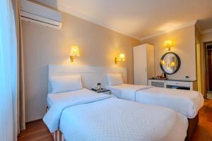 A bed or beds in a room at Peak Star Hotel