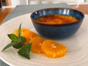 a bowl of soup and some oranges on a plate at Hotel Aqua Sopot - Destigo Hotels in Sopot