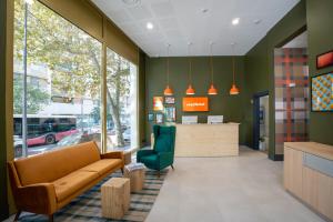 a waiting room with a couch and a chair at easyHotel Marseille Euromed in Marseille