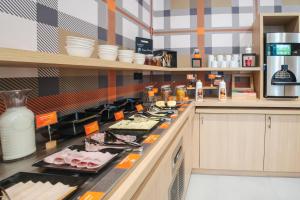 a kitchen with a counter with food on it at easyHotel Marseille Euromed in Marseille