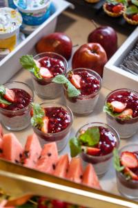 a display of fruit in small cups with fruit and vegetables at Hotel Aqua Sopot - Destigo Hotels in Sopot