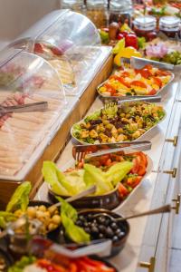 a buffet line with many different types of food at Hotel Aqua Sopot - Destigo Hotels in Sopot