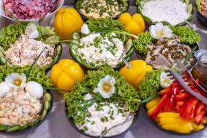a bunch of different types of food on a table at Hotel Aqua Sopot - Destigo Hotels in Sopot