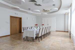 a dining room with a white table and chairs at Hotel Aqua Sopot - Destigo Hotels in Sopot
