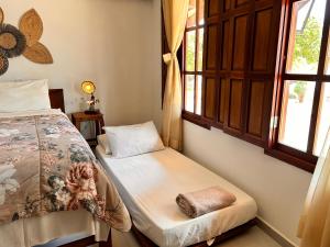 Loft Maruê Porto de Pedras客房内的一张或多张床位