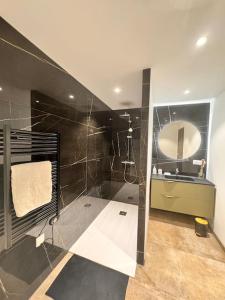 a bathroom with a shower and a sink and a mirror at Bella Vita Epinal in Épinal +36 photos