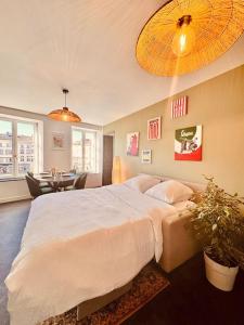 a bedroom with a large bed and a dining room at Bella Vita Epinal in Épinal