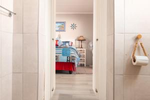 a hallway with a bedroom with a bed in it at Fisherman's Porch in Velddrif