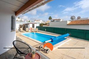 a pool with a water slide on the side of a house at #245 Quinta do Julo by Home Holidays in Albufeira