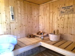 a inside of a wooden sauna with a tub at Haus Rosengarten mit Sauna in Bad Wünnenberg +29 photos