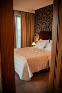 Posteľ alebo postele v izbe v ubytovaní Hotel Kuracyjny Spa & Wellness