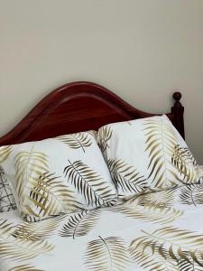 a bed with two pillows on it with at Casa do mar in São Vicente +22 photos