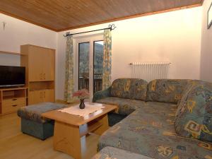 a living room with a couch and a table at Apartment Dachstein by Interhome in Filzmoos +30 photos