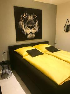 a bedroom with a bed with a picture of a lion at Ferienhaus Belvedere am Schluchsee in Schluchsee +14 photos