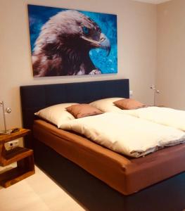 a room with two beds with a painting on the wall at Ferienhaus Belvedere am Schluchsee in Schluchsee