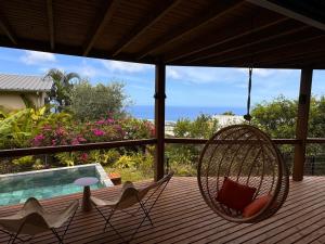 a porch with two chairs and a hammock at Villa Lauviah in Ravine Sèche