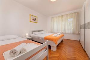 a bedroom with two beds and a window at Villa Joy in Jadranovo +56 photos