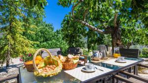 a picnic table with a basket of fruit on it at Cortijo Casablanca Priego de Cordoba by Ruralidays in Priego de Córdoba