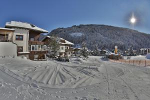 a snow covered road in front of a ski lodge at Haus Hildegard in Gerlos +43 photos
