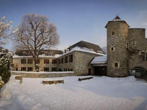 a large stone building with snow in front of it at Appartement 4 personnes à Saint Lary village - FR-1-296-231 in Saint-Lary-Soulan +12 photos