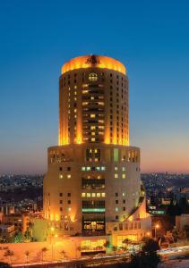 a tall building with lights on top of it at Le Royal Amman in Amman