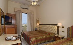 a bedroom with a bed and a table and a window at Villa Tina in Viareggio