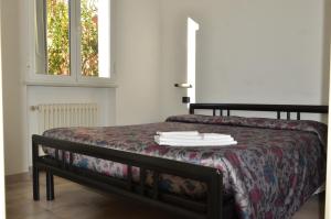 Säng eller sängar i ett rum på Residence Villa Carmen fronte mare a 50 mt