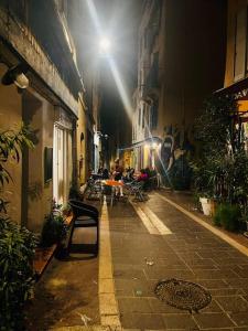 a city street at night with people sitting on benches at Studio cosy au cœur Panier in Marseille