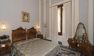 a bedroom with a bed and a window at Villa Tina Hotel in Viareggio +73 photos