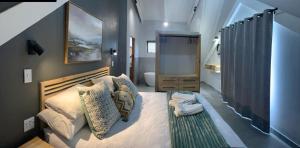 a bedroom with a large bed and a bathroom at Champagne Haven - Chalet 6 Mount Champagne in Champagne Valley