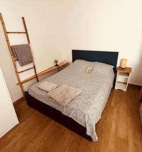 a bedroom with a bed and a wooden floor at Beau studio au coeur du Panier in Marseille