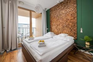 Postel nebo postele na pokoji v ubytování GO Apartments - ApartHotel
