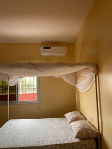 a bunk bed in a room with a window at Auberge Andel Diabou SARR in Palmarin