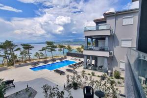 an image of a house with a swimming pool at Villas Punta Silo - luxury apartments with pool in Šilo