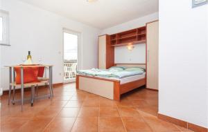 a bedroom with a bed and a desk and a table at Lovely Apartment In Kornic With Wifi in Kornić