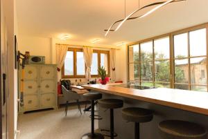 a kitchen with a counter and stools in a room at Puent Seceda-Dolomiti-Val Gardena in Ortisei
