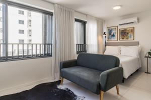 a bedroom with a bed and a chair at GO 24 by My Way in Porto Alegre +121 photos