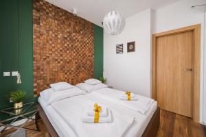 Posteľ alebo postele v izbe v ubytovaní ApartHotel Kolejowa Apartamenty