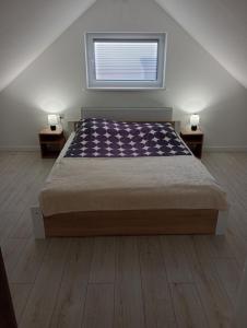 a bedroom with a large bed with two night stands at Skalny domek in Krościenko +3 photos