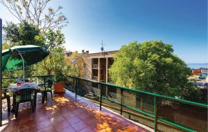 a balcony with a table and an umbrella at Beautiful Apartment In Rijeka With Wifi in Rijeka +26 photos