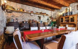 a dining room with a table and wine barrels at Lovely Home In Bribir in Bribir