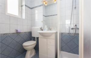 a bathroom with a toilet and a sink and a shower at Lovely Apartment In Kornic With Wifi in Kornić