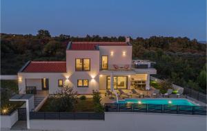 a house with a swimming pool in front of it at Nice Home In Krnica With Jacuzzi in Krnica