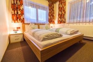 A bed or beds in a room at Pension Schweizerhof