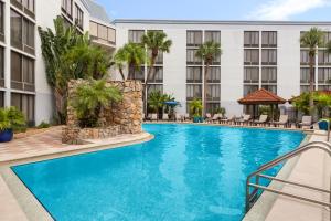 a swimming pool in front of a hotel at Doubletree by Hilton Fort Myers at Bell Tower Shops in Fort Myers