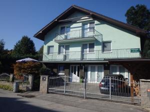 a white house with a fence in front of it at Privat Ján Vereš in Rajecké Teplice