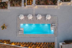an overhead view of a swimming pool with a resort at Archon Seaside Retreat in Plaka